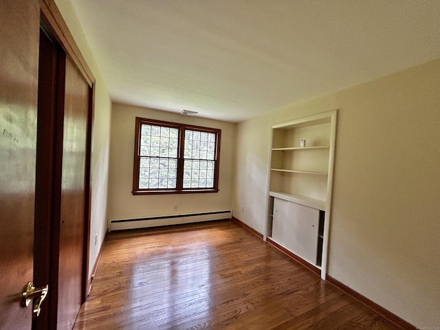 364 Locust Rd, Harwinton, CT 06791 - empty room featuring baseboard heating, wood finished floors, and built in shelves