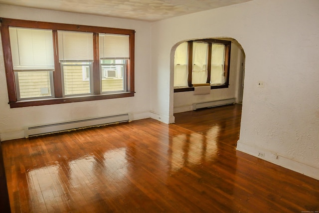 77 Beardsley Park Ter, Bridgeport, CT 06610 - spare room with a baseboard radiator, baseboard heating, arched walkways, and hardwood / wood-style flooring