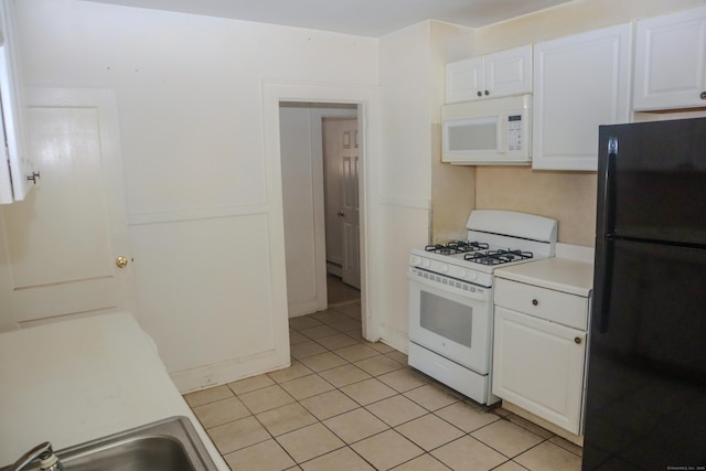 77 Beardsley Park Ter, Bridgeport, CT 06610 - kitchen with white appliances, light tile patterned flooring, white cabinets, and light countertops