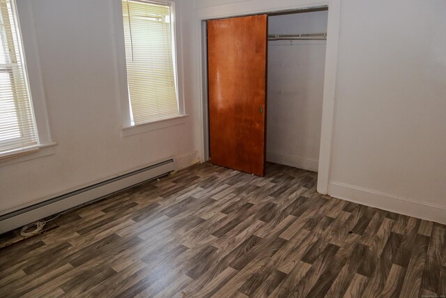 77 Beardsley Park Ter, Bridgeport, CT 06610 - unfurnished bedroom featuring baseboard heating, a closet, and dark wood finished floors