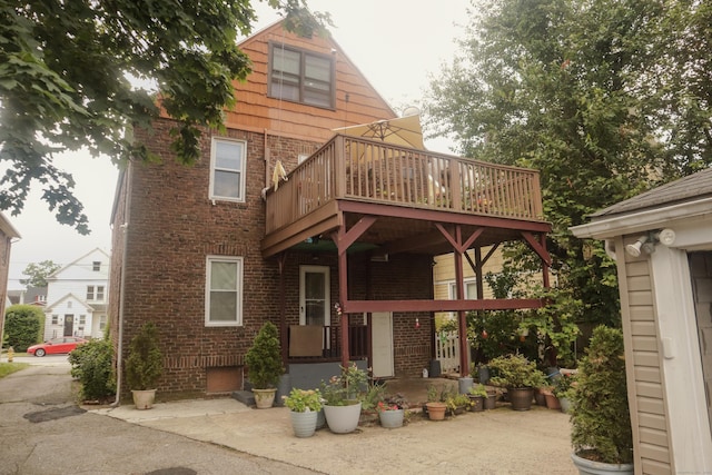 77 Beardsley Park Ter, Bridgeport, CT 06610 - rear view of property featuring brick siding and a deck