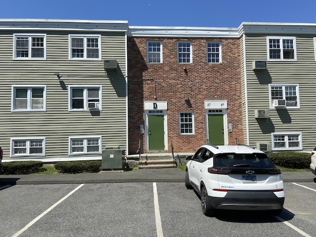 5 Woodside Ave Unit D41, Danbury, CT 06810 - view of front of home featuring uncovered parking, cooling unit, and brick siding