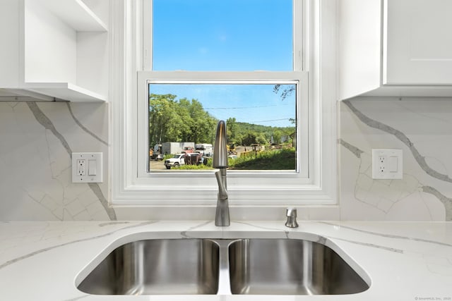 15 Beech St, North Branford, CT 06471 - kitchen view of white cabinetry, light stone counters, and backsplash