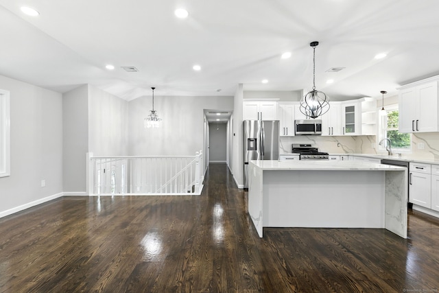15 Beech St, North Branford, CT 06471 - kitchen featuring appliances with stainless steel finishes, a kitchen island, a chandelier, white cabinetry, and recessed lighting