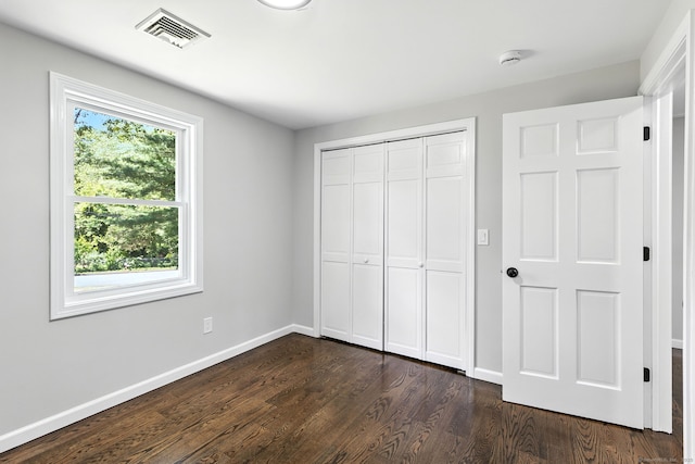 15 Beech St, North Branford, CT 06471 - unfurnished bedroom with dark wood-type flooring and a closet