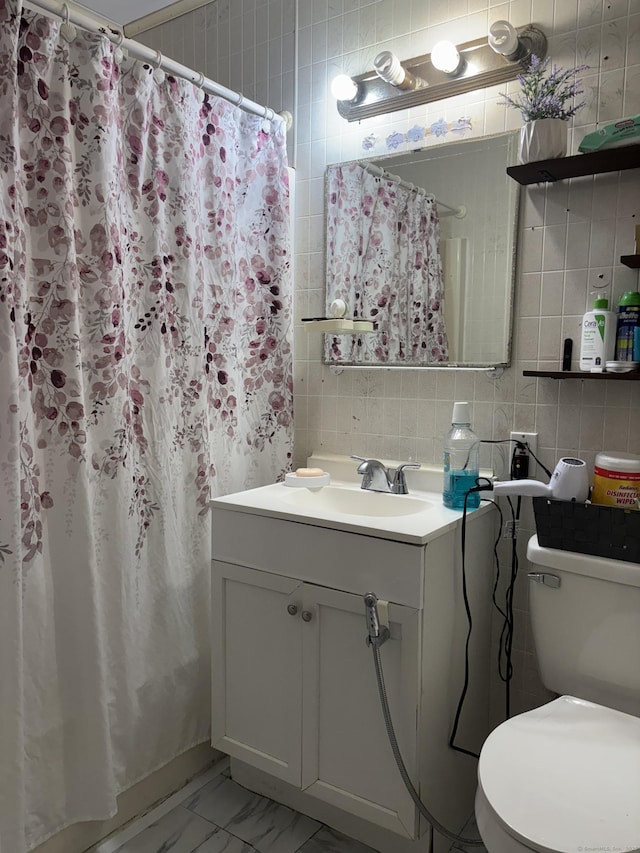 12 Cedar Ct Unit D, East Haven, CT 06513 - full bath with vanity, marble finish floors, tile walls, curtained shower, and backsplash