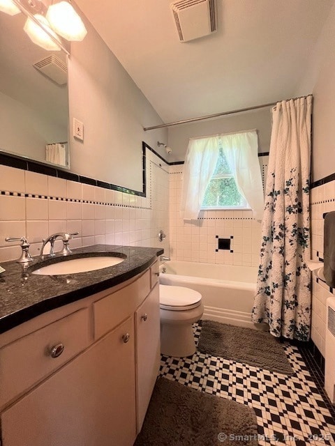 49 Geneva Ave, West Hartford, CT 06107 - bathroom featuring tile walls, shower / bath combination with curtain, tile patterned floors, vanity, and radiator