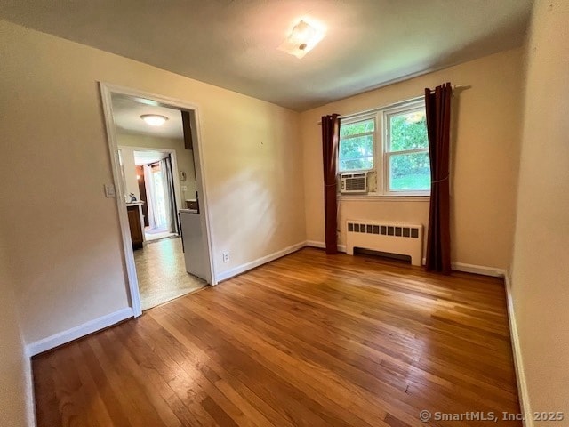 49 Geneva Ave, West Hartford, CT 06107 - unfurnished room featuring radiator heating unit, wood finished floors, and cooling unit