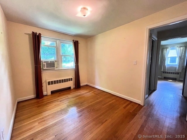 49 Geneva Ave, West Hartford, CT 06107 - spare room with radiator, wood finished floors, and cooling unit