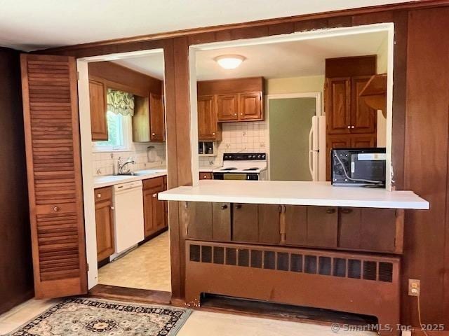 49 Geneva Ave, West Hartford, CT 06107 - kitchen featuring white appliances, tasteful backsplash, light countertops, and a peninsula