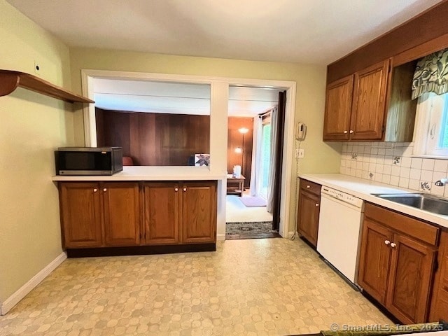 49 Geneva Ave, West Hartford, CT 06107 - kitchen with white dishwasher, stainless steel microwave, brown cabinets, and light countertops