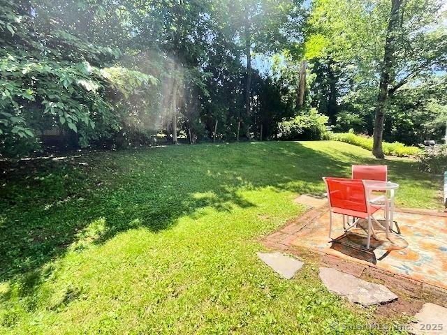 49 Geneva Ave, West Hartford, CT 06107 - view of grassy yard featuring a patio