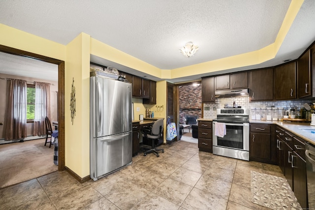 64 Melcon Dr, Southington, CT 06489 - kitchen featuring appliances with stainless steel finishes, dark brown cabinetry, under cabinet range hood, a textured ceiling, and backsplash