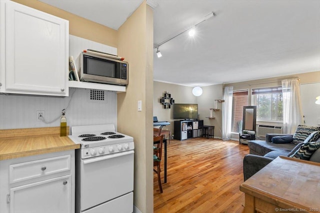 230 W Walk Walk Unit 230, West Haven, CT 06516 - kitchen with electric range, track lighting, white cabinetry, stainless steel microwave, and light wood-style floors