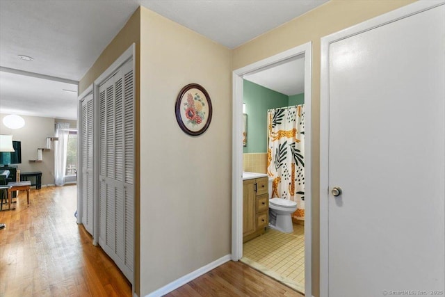 230 W Walk Walk Unit 230, West Haven, CT 06516 - corridor with wood finished floors and baseboards