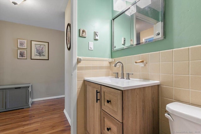 230 W Walk Walk Unit 230, West Haven, CT 06516 - bathroom with tile walls, vanity, wood finished floors, and a wainscoted wall