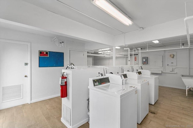 230 W Walk Walk Unit 230, West Haven, CT 06516 - communal laundry room featuring washing machine and dryer and light wood-style floors