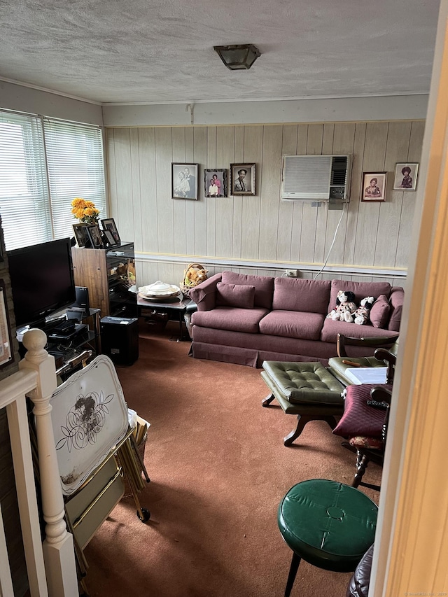 living area with carpet floors, an AC wall unit, wood walls, and a textured ceiling
