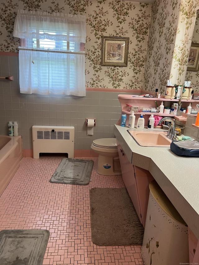 full bathroom with radiator heating unit, wallpapered walls, a wainscoted wall, vanity, and tile walls