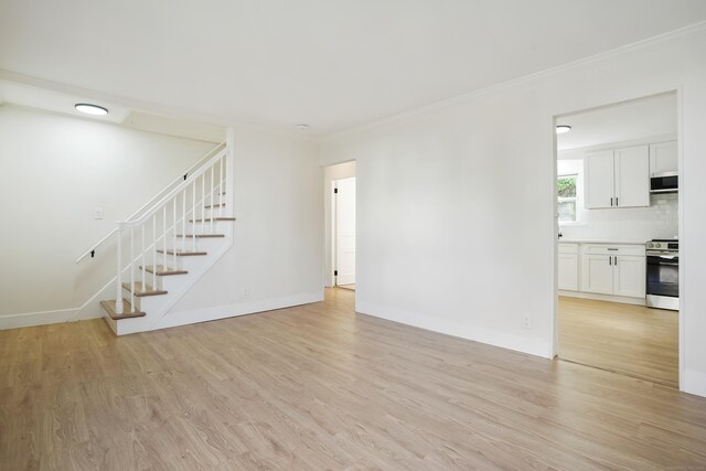 24 S Ave, Danbury, CT 06810 - unfurnished living room with light wood-style floors, stairs, and ornamental molding