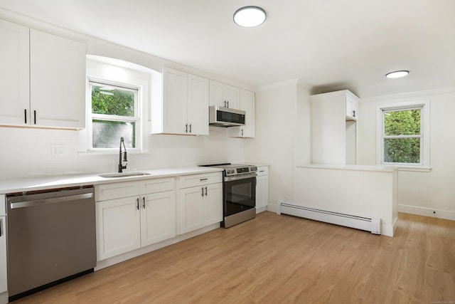 24 S Ave, Danbury, CT 06810 - kitchen with appliances with stainless steel finishes, a baseboard radiator, light wood-type flooring, tasteful backsplash, and light countertops