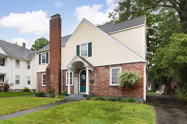 41 Northridge Ave, Torrington, CT 06790 - view of front facade featuring brick siding, a front lawn, and a chimney
