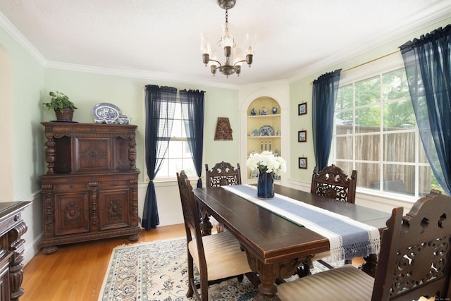 41 Northridge Ave, Torrington, CT 06790 - dining space featuring a chandelier, light wood finished floors, built in features, ornamental molding, and plenty of natural light