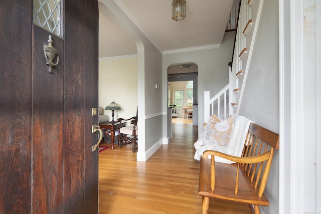 41 Northridge Ave, Torrington, CT 06790 - foyer entrance featuring arched walkways, wood finished floors, stairway, and crown molding