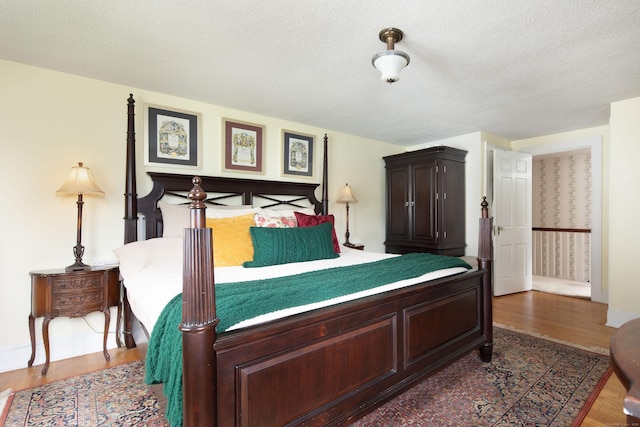41 Northridge Ave, Torrington, CT 06790 - bedroom featuring wood finished floors, a textured ceiling, and wallpapered walls