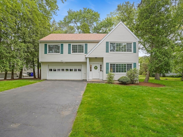 100 Mayfair Rd, Fairfield, CT 06824 - view of front of house with asphalt driveway, an attached garage, and a front lawn