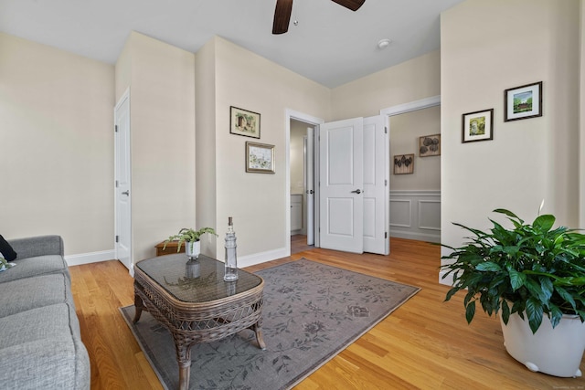 115 Webster Ln Unit 115, Middletown, CT 06457 - living area featuring a ceiling fan, light wood-style flooring, and a wainscoted wall