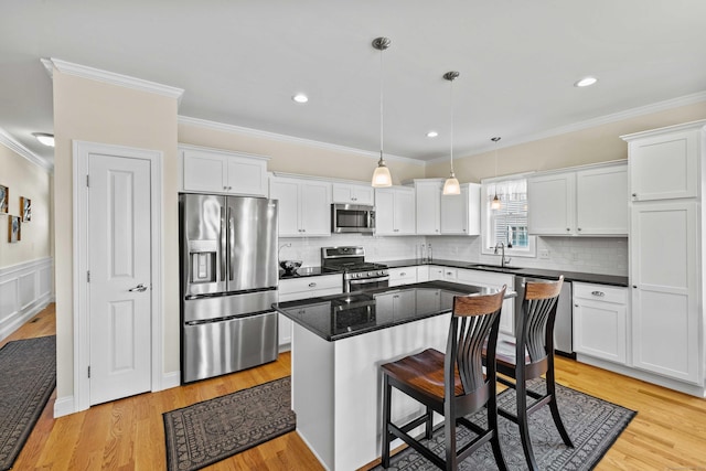 115 Webster Ln Unit 115, Middletown, CT 06457 - kitchen with appliances with stainless steel finishes, ornamental molding, white cabinetry, tasteful backsplash, and recessed lighting