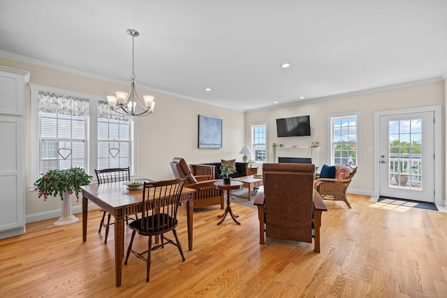 115 Webster Ln Unit 115, Middletown, CT 06457 - dining space featuring crown molding, light wood-style flooring, a chandelier, a fireplace, and recessed lighting