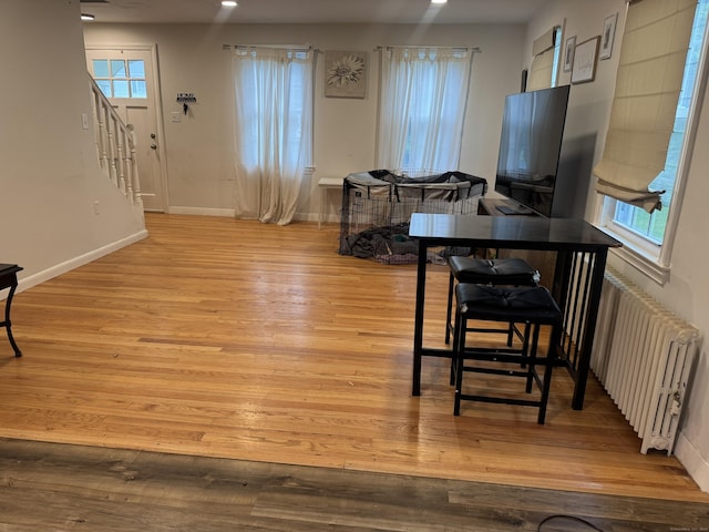 24 N Forest Cir, West Haven, CT 06516 - dining area with radiator, stairway, light wood-style floors, and recessed lighting