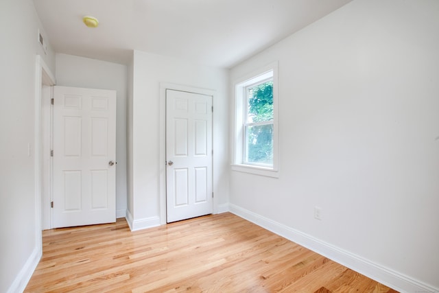 289 E Ave, Bridgeport, CT 06610 - unfurnished bedroom with light wood-style floors and a closet