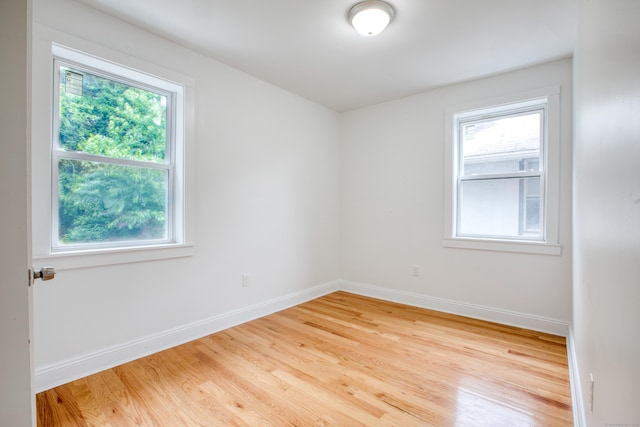 289 E Ave, Bridgeport, CT 06610 - empty room with wood finished floors and baseboards
