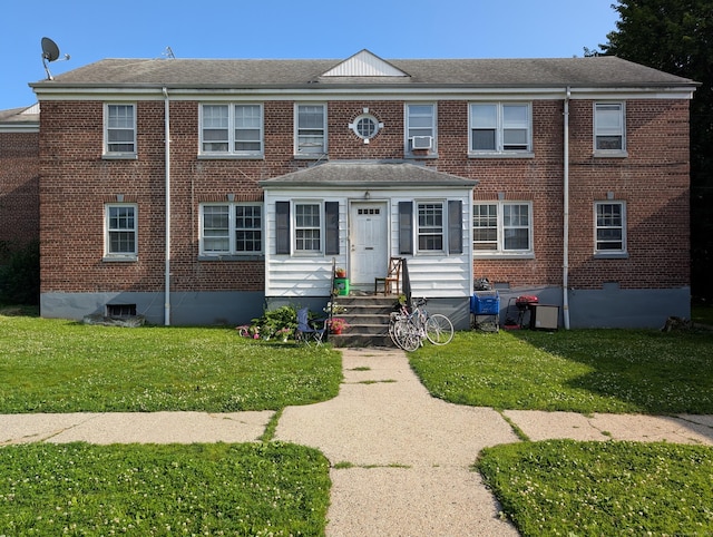 901 William St Apt A, Bridgeport, CT 06608 - view of front facade with brick siding, a front yard, and a shingled roof