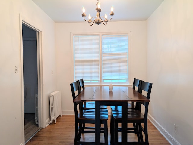901 William St Apt A, Bridgeport, CT 06608 - dining space with radiator, a chandelier, and wood finished floors