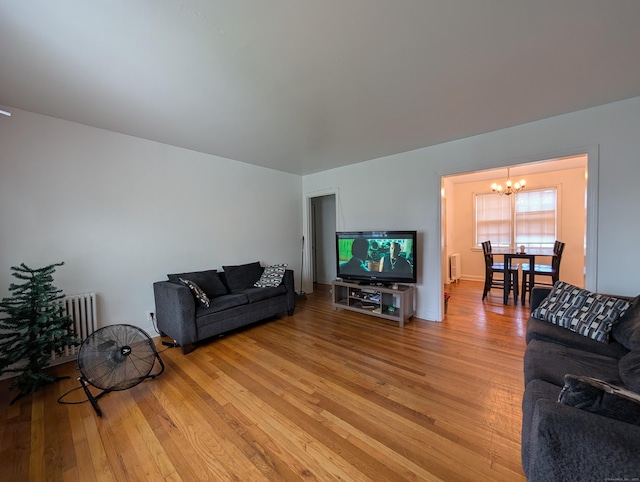 901 William St Apt A, Bridgeport, CT 06608 - living area featuring a chandelier, light wood finished floors, and radiator heating unit
