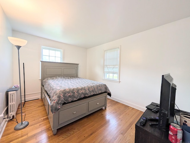901 William St Apt A, Bridgeport, CT 06608 - bedroom with light wood-style flooring, multiple windows, and radiator heating unit