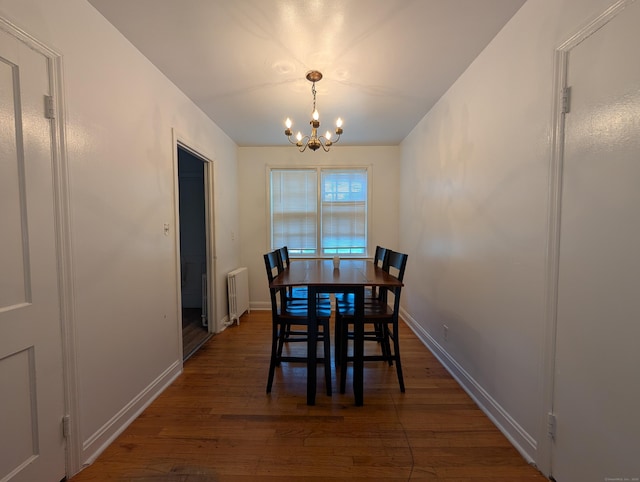 901 William St Apt A, Bridgeport, CT 06608 - dining area with radiator, a chandelier, and dark wood-type flooring