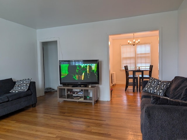 901 William St Apt A, Bridgeport, CT 06608 - living room with radiator heating unit, a chandelier, and wood finished floors