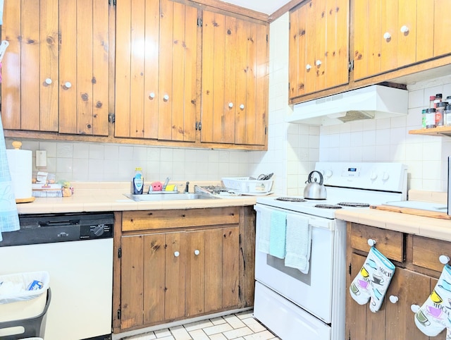 901 William St Apt B, Bridgeport, CT 06608 - kitchen with white appliances, under cabinet range hood, tasteful backsplash, light countertops, and brown cabinets