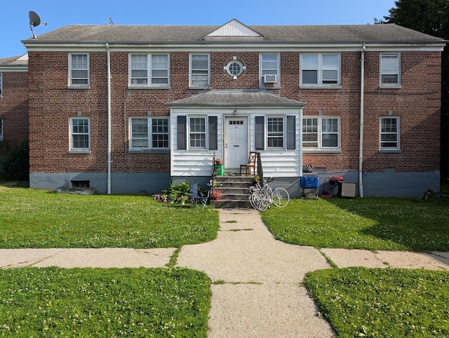 901 William St Apt C, Bridgeport, CT 06608 - view of front facade with brick siding, a front yard, and cooling unit