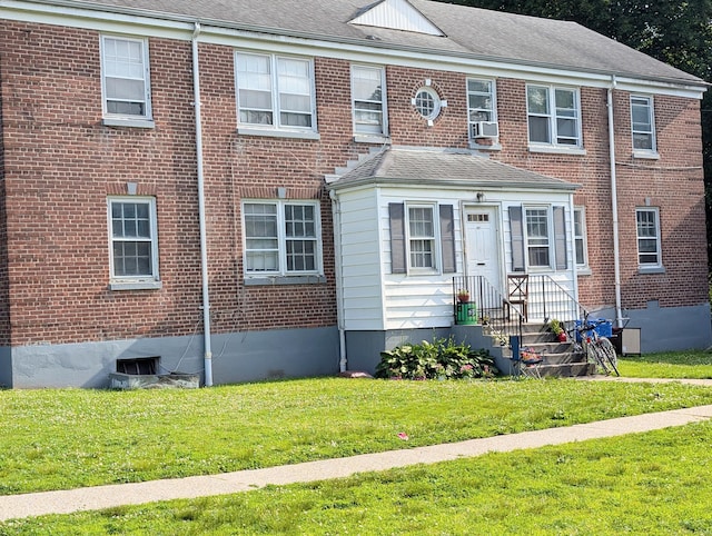 901 William St Apt C, Bridgeport, CT 06608 - townhome / multi-family property featuring a front lawn, brick siding, and a shingled roof