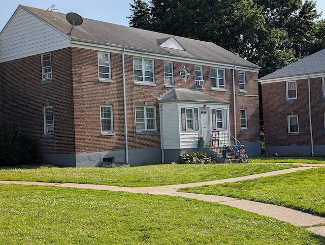 901 William St Apt D, Bridgeport, CT 06608 - view of front of home featuring a front lawn, brick siding, and cooling unit