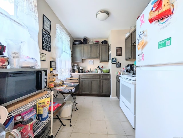 901 William St Apt D, Bridgeport, CT 06608 - kitchen featuring white appliances, light tile patterned flooring, light countertops, and dark brown cabinetry