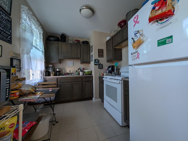 901 William St Apt D, Bridgeport, CT 06608 - kitchen with white appliances, light countertops, light tile patterned floors, and dark brown cabinets
