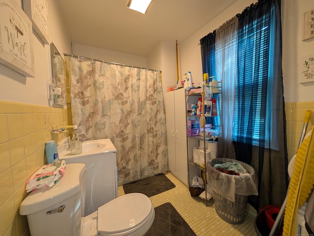 901 William St Apt D, Bridgeport, CT 06608 - full bathroom featuring tile walls, tile patterned flooring, a wainscoted wall, vanity, and curtained shower