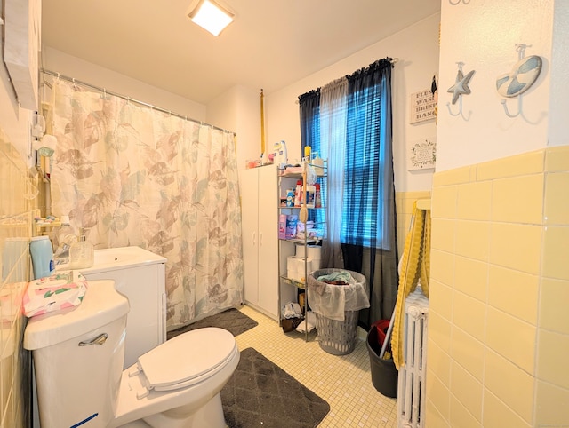 901 William St Apt D, Bridgeport, CT 06608 - bathroom featuring a wainscoted wall, a shower with shower curtain, and tile walls